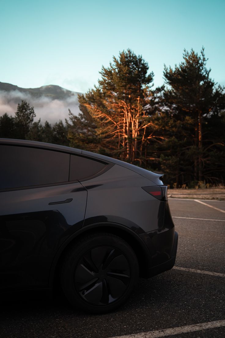 Tesla Model Y at sunrise with mountain backdrop